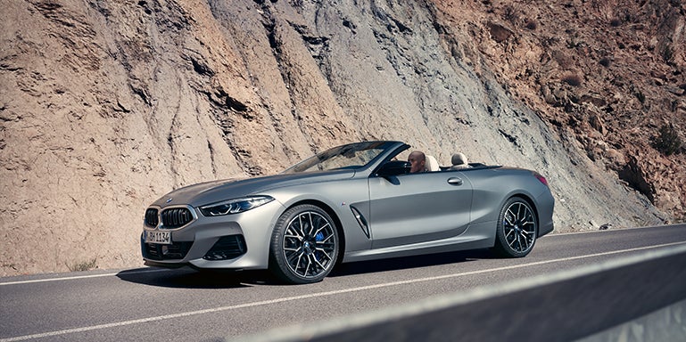 Grey BMW convertible driving around a mountain | BMW of Morristown in Morristown NJ