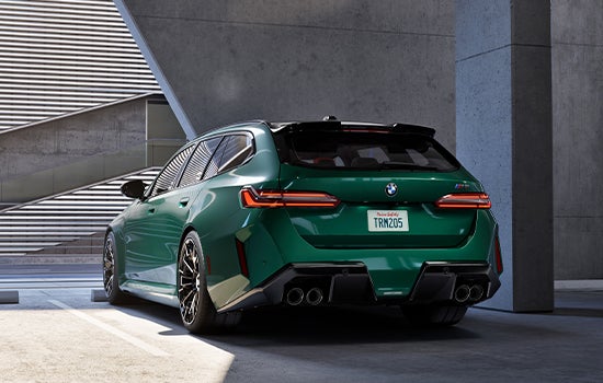 Green BMW M5 Touring parked in garage. | BMW of Morristown in Morristown NJ
