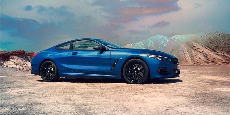 Blue BMW 8 Series parked with desert landscape | BMW of Morristown in Morristown NJ
