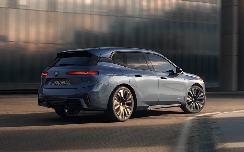 The BMW iX driving with the front wheel turned. | BMW of Morristown in Morristown NJ